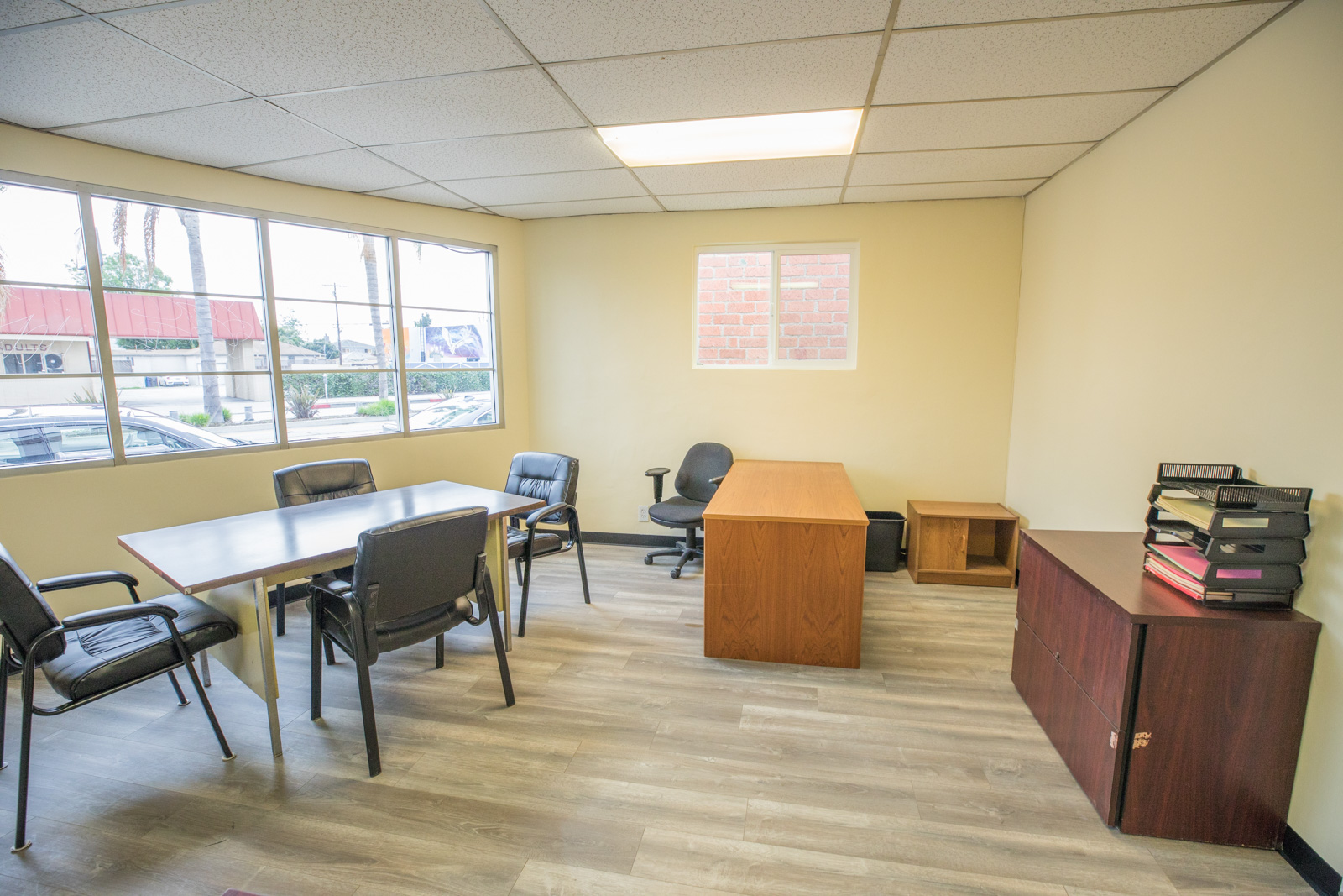 Private office and meeting room with large street-facing windows
